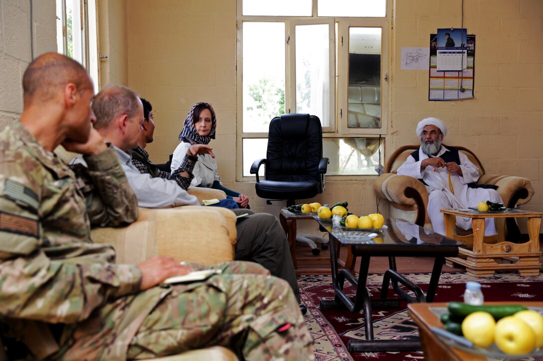 U.S. Consul General Jillian Burns, fourth from left, talks with Hajji Bashir Khan, right, head of the Farah provincial council, while U.S. Navy Cmdr. Louis McCray, left, and Ray Sudweeks, second from left, U.S. State Department senior civilian representative in Farah, listen during a meeting at the governor's compound in Farah City, Afghanistan, April 11, 2013. McCray is the commanding officer of Provincial Reconstruction Team Farah.