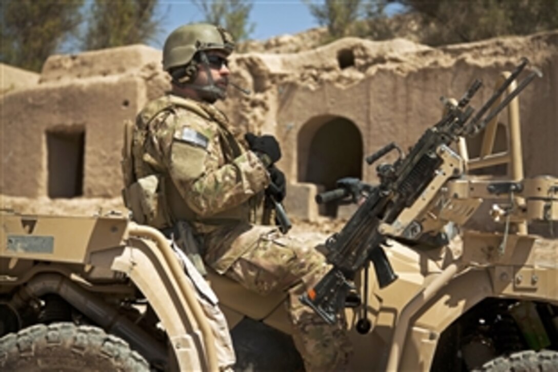 A coalition force member provides security during a patrol with Afghan special forces to escort a district governor in Helmand province, Afghanistan, April 14, 2013. Afghan forces have been taking the lead in operations to bring security and stability to the people of Afghanistan.
