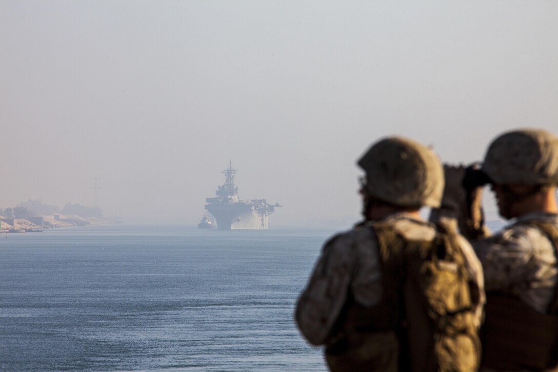 Lance Cpls. Joseph Fields and John Vloyanetes, amphibious assault vehicle platoon, Company K, Battalion Landing Team 3/2, 26th Marine Expeditionary Unit (MEU), scan their surroundings aboard dock landing ship USS Carter Hall (LSD 50), while passing through the Suez Canal ahead of amphibious assault ship USS Kearsarge (LHD 3) April 5, 2013. The 26th MEU is currently deployed as part of the Kearsarge Amphibious Ready Group to the 5th Fleet area of responsibility. The MEU operates continuously across the globe, providing the president and unified combatant commanders with a forward-deployed, sea-based quick reaction force. The MEU is a Marine Air-Ground Task Force capable of conducting amphibious operations, crisis response, and limited contingency operations.
(U.S. Marine Corps photo by Staff Sgt. Edward Guevara/Released)