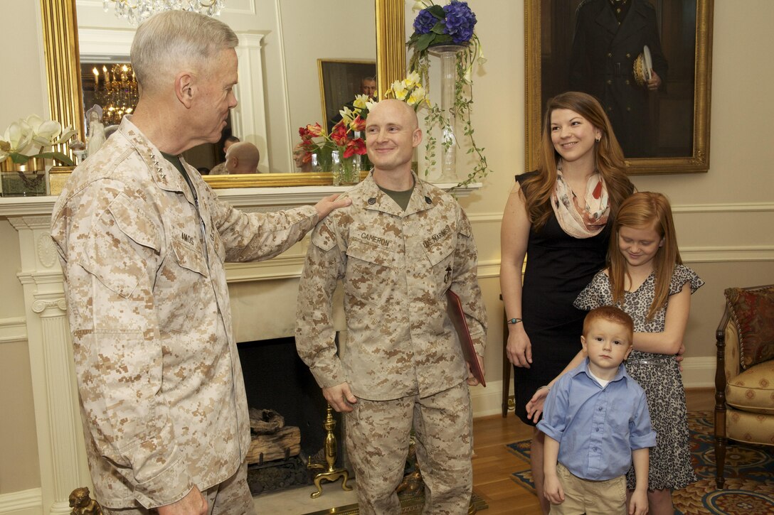 The 35th commandant of the Marine Corps, General James F. Amos, promotes Sergeant Travis L. Cameron to the rank of Staff Sergeant at the Home of the Commandants in Washington, D.C., April 8, 2013. (U.S. Marine Corps photo by Sgt. Mallory S. VanderSchans)(RELEASED)
