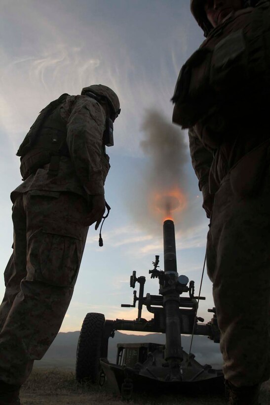 MARINE CORPS BASE CAMP PENDLETON, Calif. –Corporal Matthew Christman, a field artillery cannoneer and a mortar section chief, serving with 2nd Battalion 11th Marine Regiment supervises as Lance Cpl. Kevin Rodriguez fires the M-327 Towed Rifle Mortar Weapon while conducting a firing mission during a live-fire training exercise, here April 3, 2013. Rodriguez a 21-year-old-native of Long Beach, Calif., said he has the most fun job on the gun team because he is in charge of actually firing the weapon system.