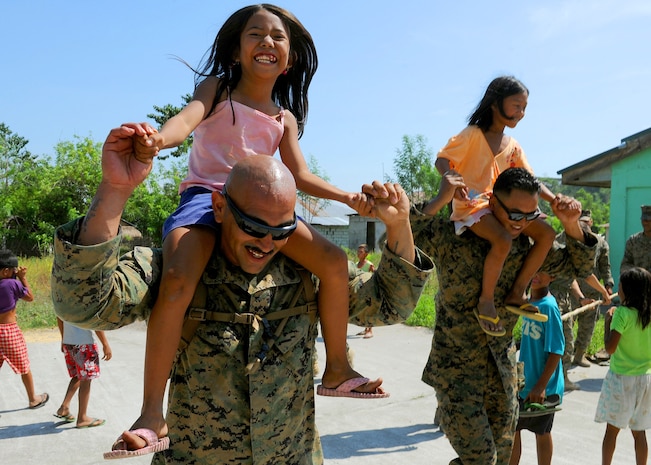 U.S. Marines Staff Sgt. Ruben Ramirez, left, a warehouseman, and Cpl. David Long, a packing specialist, both with Combat Logistics Regiment 35, 3rd Marine Logistics Group, III Marine Expeditionary Force, playfully carry Angeline, left, and Janah who are students at Maruglo Elementary School in Crow Valley, Philippines, April 12 during ongoing community relations events at Balikatan 2013, an annual Philippine-U.S. bilateral exercise. Humanitarian assistance and training activities enable the Philippine and U.S. forces to build lasting relationships, train together and provide assistance in communities where the need is the greatest.