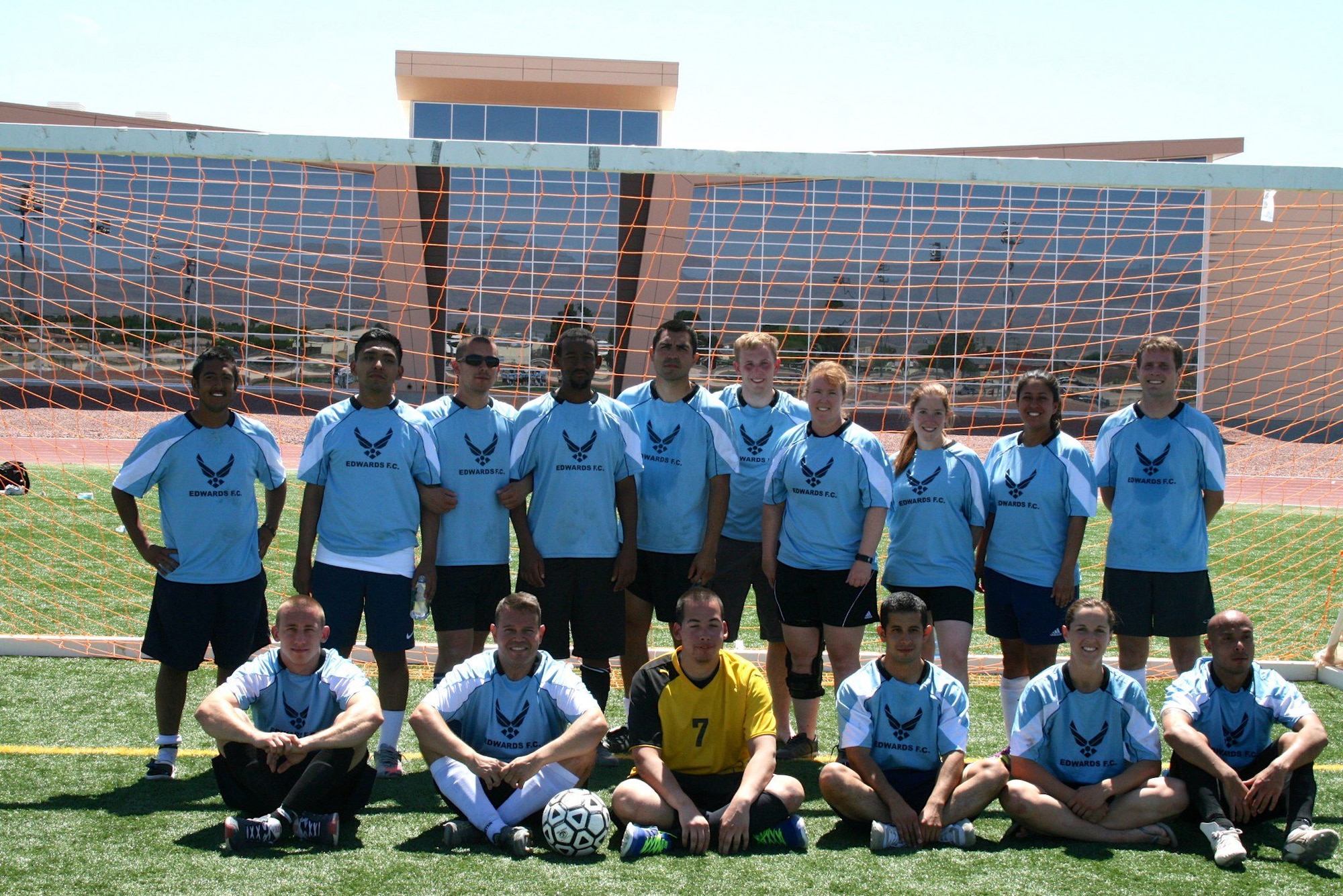 The Edwards Football Club Team. Standing from left: Andres “Pancho” Suarez, Airman 1st Class Omar Venegaz-Montes, Senior Airman Nazar “Santi” Santillan-Mondaca, Andrew Neises, Tech. Sgt. Omar Duarte, Senior Airman Tyler Baumann, Maj. Dori Baker, Raina Saccone, Tech. Sgt. Isha Navarro-Carroll, Capt. Joseph Reno.  Sitting from left to right: Staff Sgt. Dennis Franske, Maj. Oscar Corredor, Airman 1st Class Adam Ayala, Staff Sgt. Jonathan Mendez, Julie Clark, Tech. Sgt. Hector Fernandez.  Not pictured: 2nd Lt. Mike Estacion. (U.S. Air Force photo by Maj. Peter Gbelia)