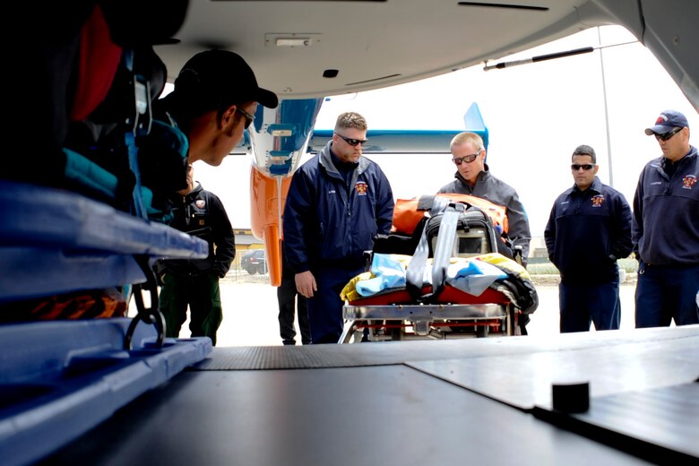 LOMPOC, Calif. – Aaron Johnson, a California Shock Trauma Air Rescue nurse, briefs the Vandenberg fire department on how they load a patient at the Lompoc Airport Thursday, April 11, 2013. Vandenberg Fire Department members trained with the CALStar flight crew to ensure patients can get to a trauma unit within the 60 minute window known as the golden hour. (U.S. Air Force photo/Airman Yvonne Morales)