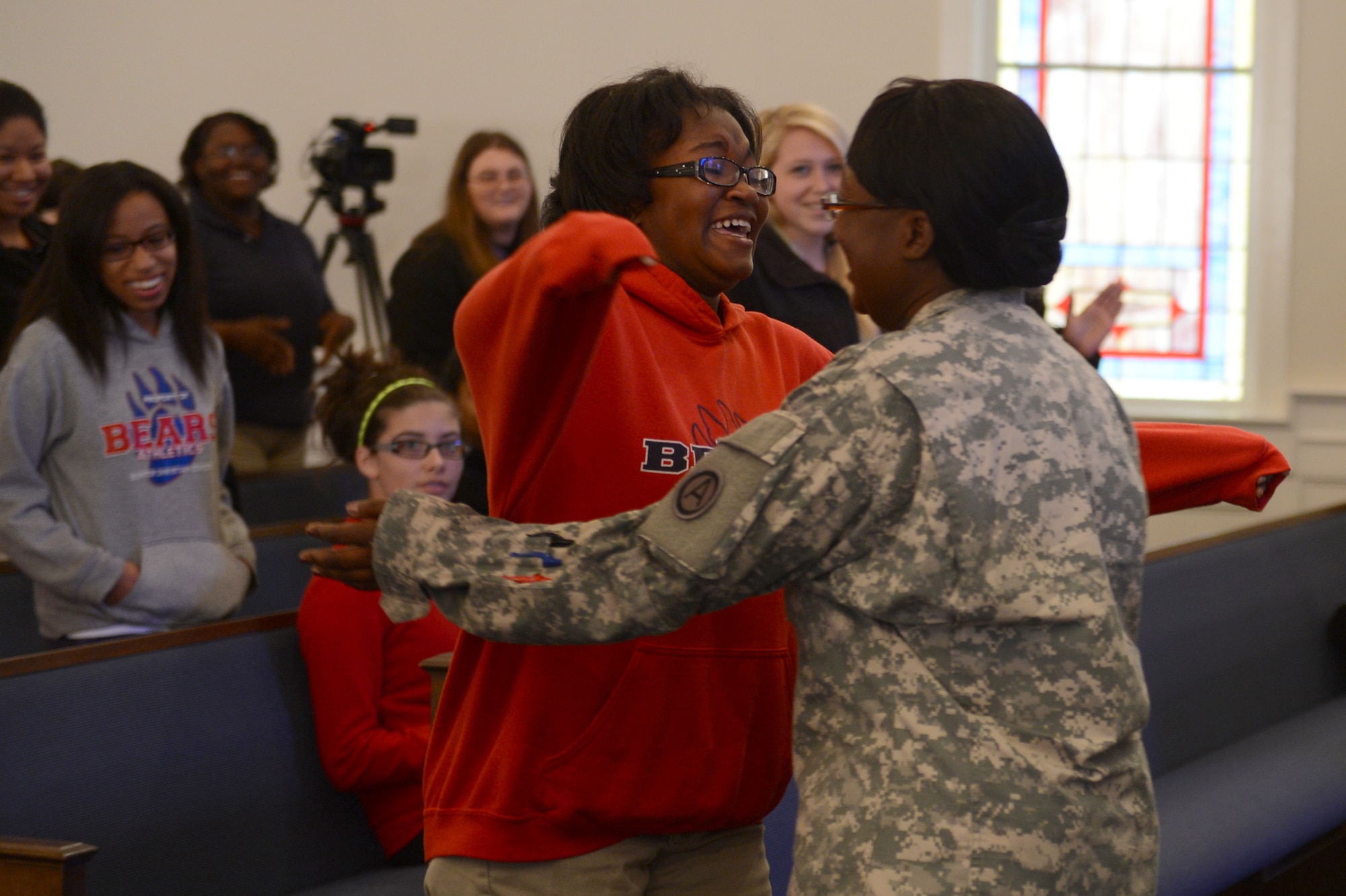 Dejsha Tatum sees her mother, U.S. Army Maj. Laura Byrd, Third Army/U.S. Army Central research analyst, for the first time in eight months when Byrd surprises her at the Sumter Christian School, S.C., April 16, 2013. Members of the school and Third Army/ARCENT helped Byrd arrange the surprise of her return from deployment to Kuwait. (U.S. Air Force photo by Airman 1st Class Krystal M. Jeffers/Released)