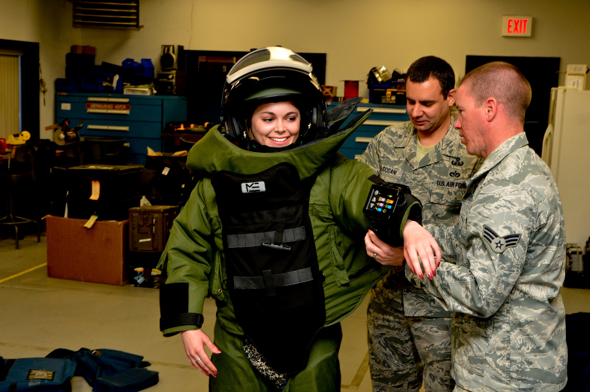 Tech Sgt. Christopher Adjoodani, from the 436th Civil Engineer Squadron Explosive Ordnance Disposal Flight, demonstrates the the EOD 9 Bomb Suit used to render explosives safe to news reporter, Ashton Brown, from the Delaware State News, at Dover Air Force Base, Del., April 16, 2013. (U.S. Air Force photo/David S. Tucker)

