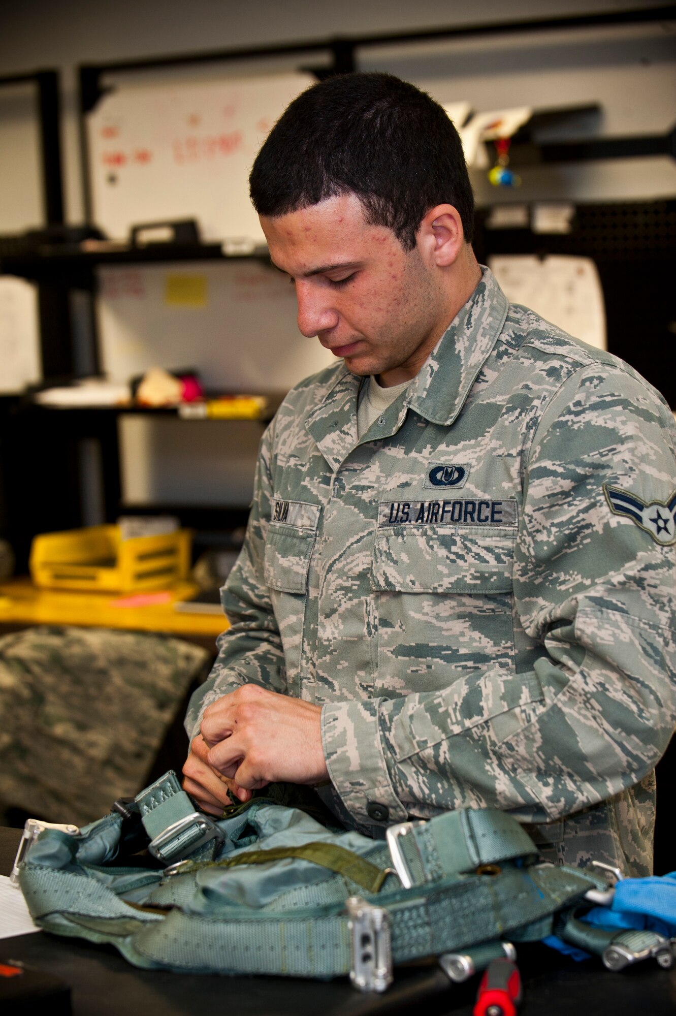 Airman 1st Class Anthony Silva, U.S. Air Force Weapons School aircrew flight equipment apprentice, conducts an inspection on a flight harness April 15, 2013, at Nellis Air Force Base, Nev. Life support performs routine inspections to ensure aircrew flight equipment is in mission-ready use. (U.S. Air Force photo/Senior Airman Brett Clashman)