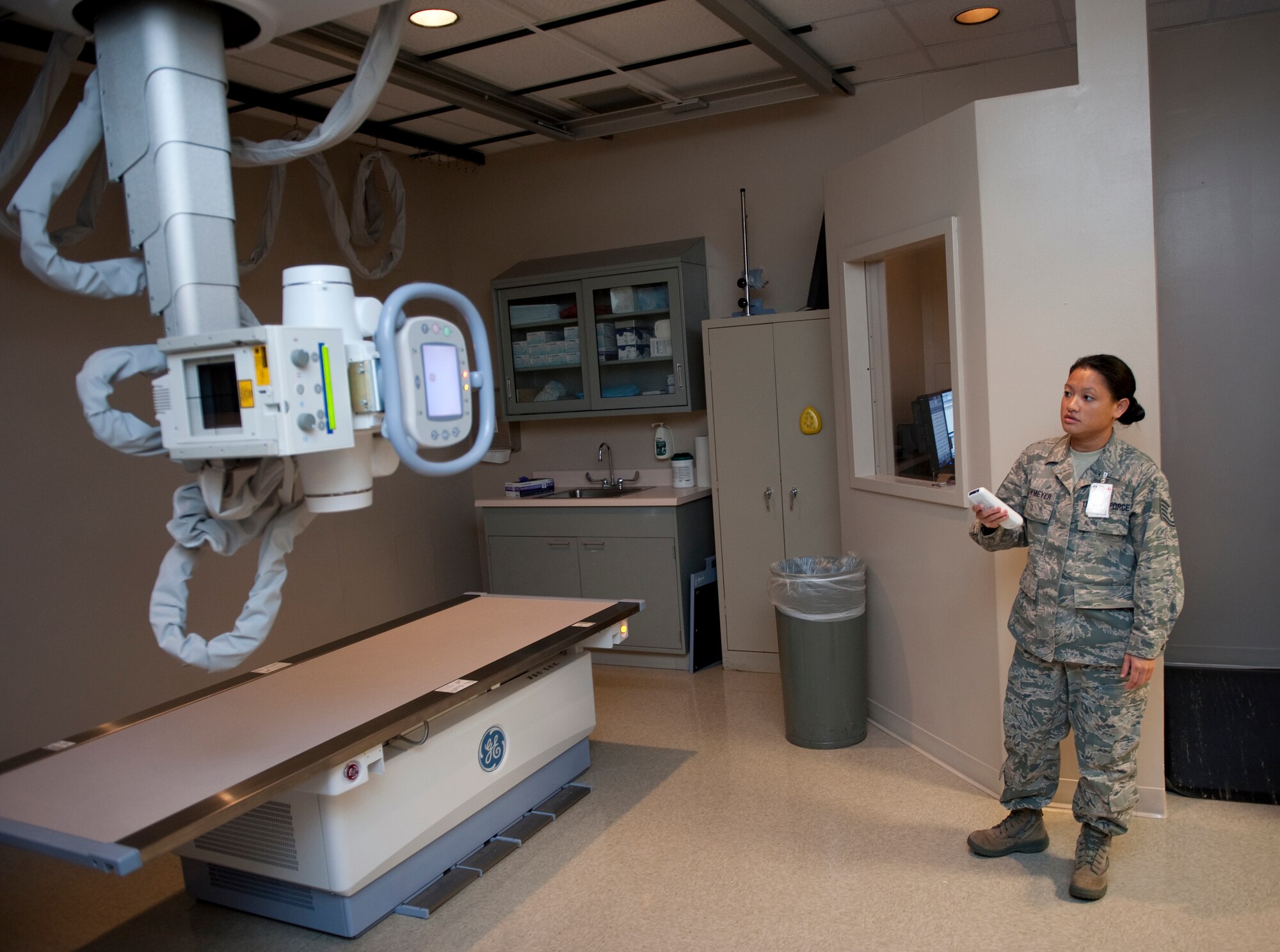 U.S. Air Force Tech. Sgt. Mia Newmeyer, non-commissioned officer in charge radiology department for 1st Special Operations Medical Support Squadron, demonstrates how to operate the new automated GEXR 650 radiology model. The GEXR 650 model produces higher quality images which will help with diagnostics and treatments of patients. (U.S. Air Force photo/ Airman 1st Class Nigel Sandridge)