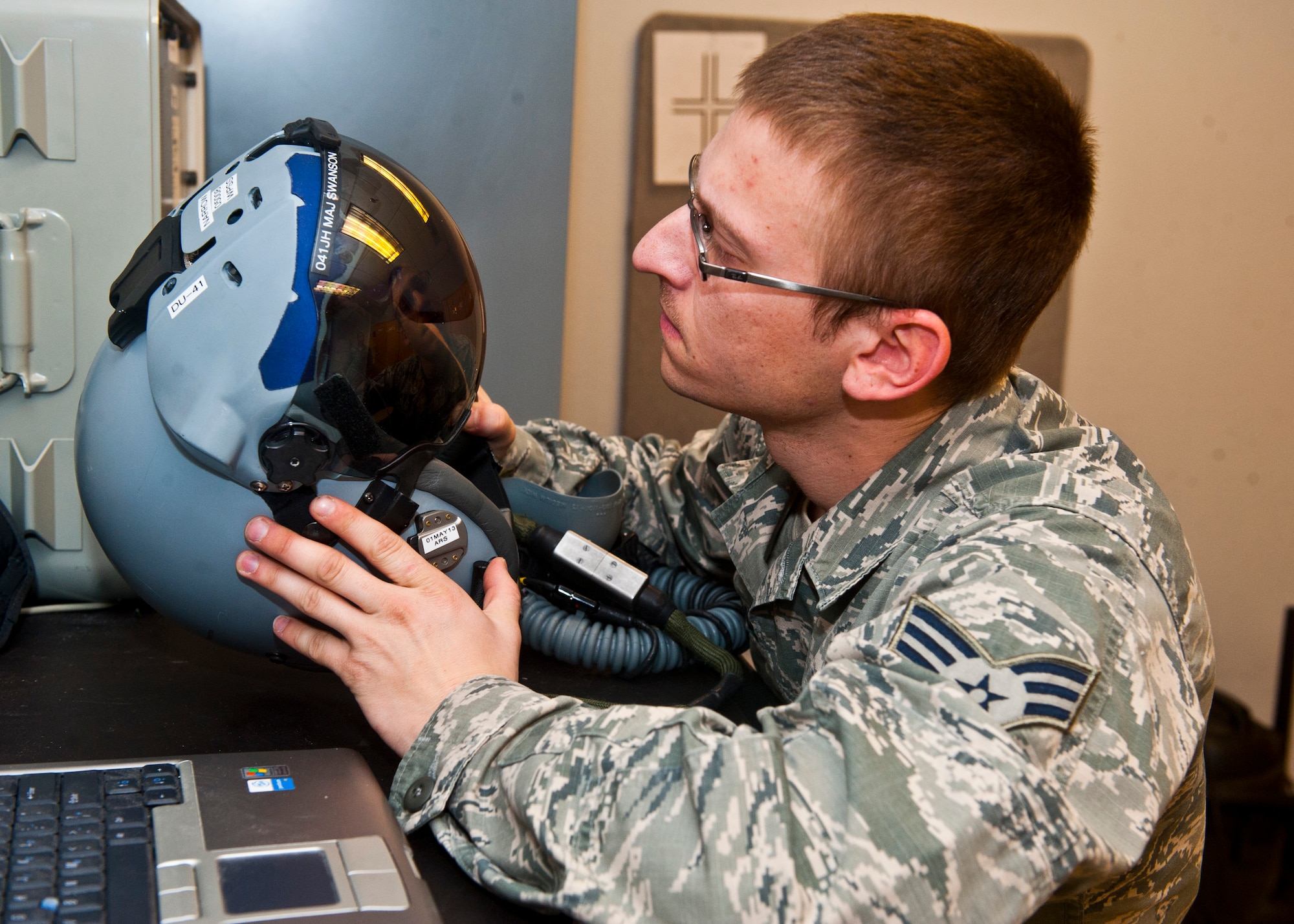 Senior Airman Brett Schindler, U.S. Air Force Weapons School aircrew flight equipment journeyman, performs an inspection on a flight helmet April 12, 2013, at Nellis Air Force Base, Nev. Life support installs different pieces of equipment daily depending of the flight crews that conduct missions that day. (U.S. Air Force photo/Senior Airman Brett Clashman)