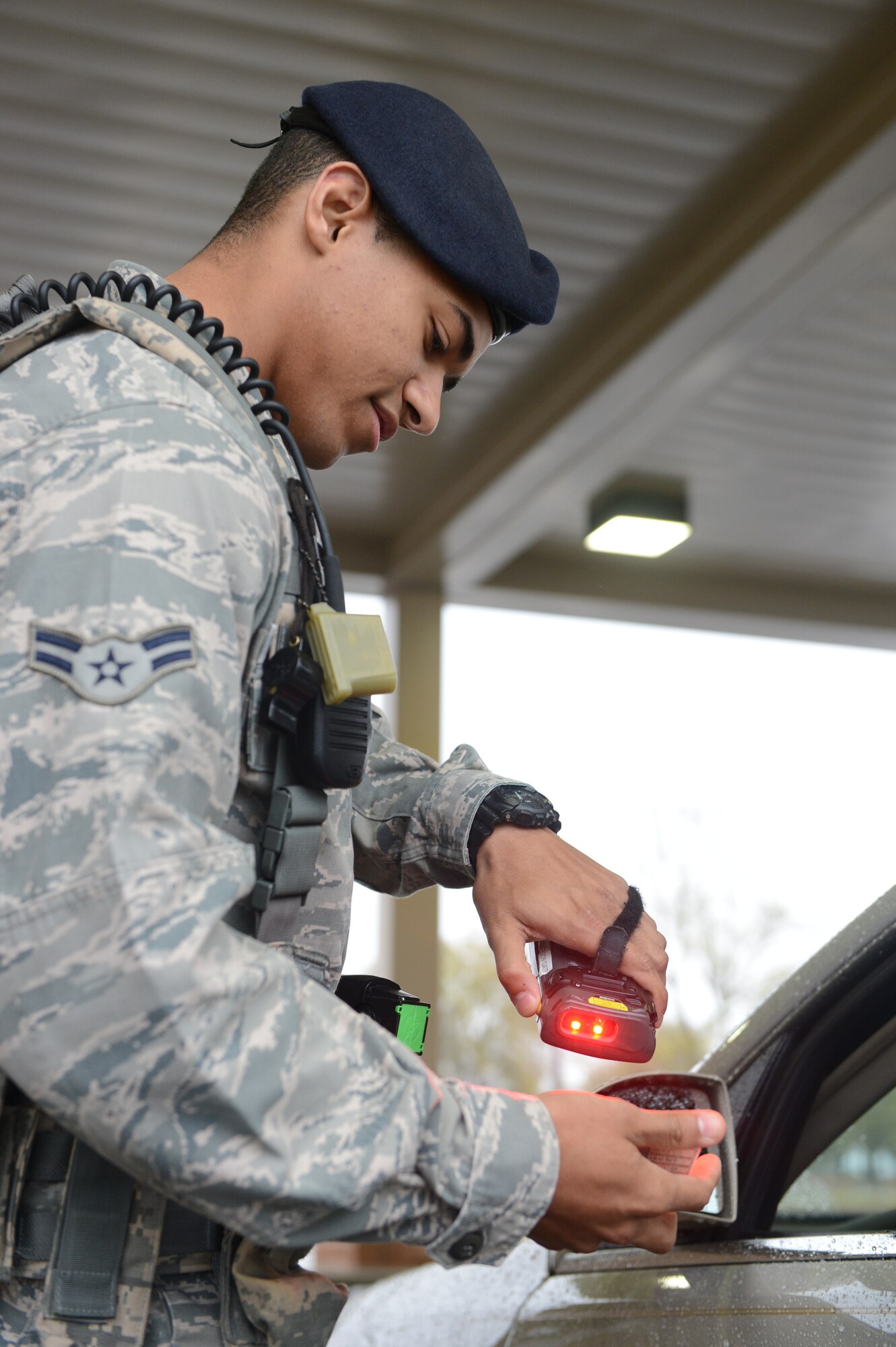 Airman 1st Class Dwayne Bolden, 20th Security Forces Squadron entry controller ,checks IDs at one of the gates at Shaw Air Force Base, S.C., April 5, 2013. The 20th SFS are tasked with the mission to secure and defend Shaw and they are expected to protect the base and its assets 24/7.  Each week they work eight- to ten-hour shifts, six days a week, before having three days off. (U.S. Air Force photo by Airman 1st Class Krystal M. Jeffers/Released)