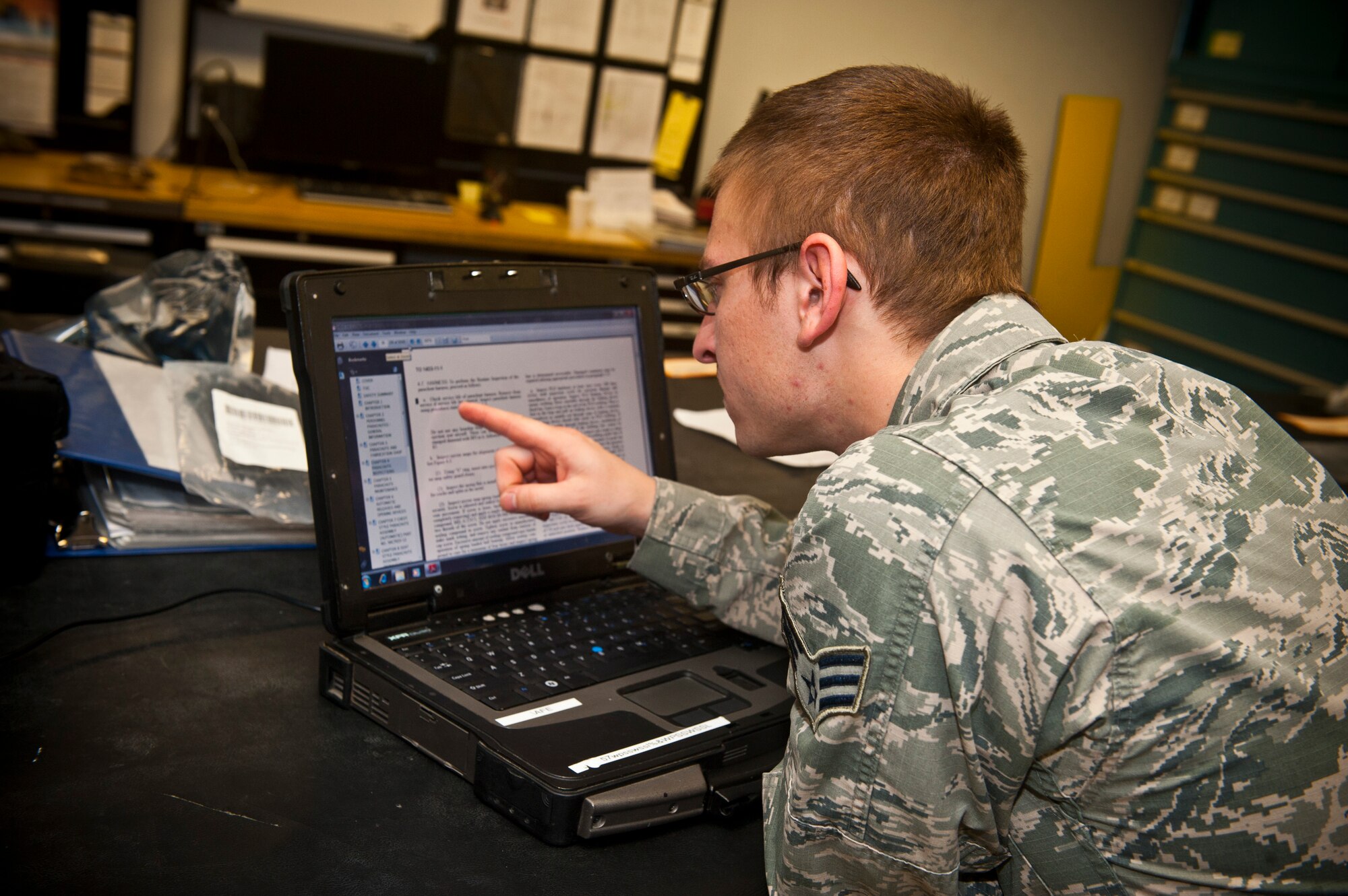 Senior Airman Brett Schindler, U.S. Air Force Weapons School aircrew flight equipment journeyman, reads through an electronic technical order log April 12, 2013, at Nellis Air Force Base, Nev. Life support maintains inspection and accountability documentation on aircrew flight equipment to ensure it is properly working at all times. (U.S. Air Force photo/Senior Airman Brett Clashman)