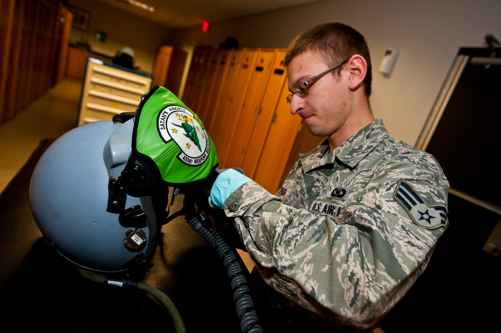 Senior Airman Brett Schindler, U.S. Air Force Weapons School aircrew flight equipment journeyman, makes adjustments to a flight helmet April 12, 2013, at Nellis Air Force Base, Nev. Life support can provide adjustments and repairs to fabric and rubber components on protective clothing. (U.S. Air Force photo/Senior Airman Brett Clashman)