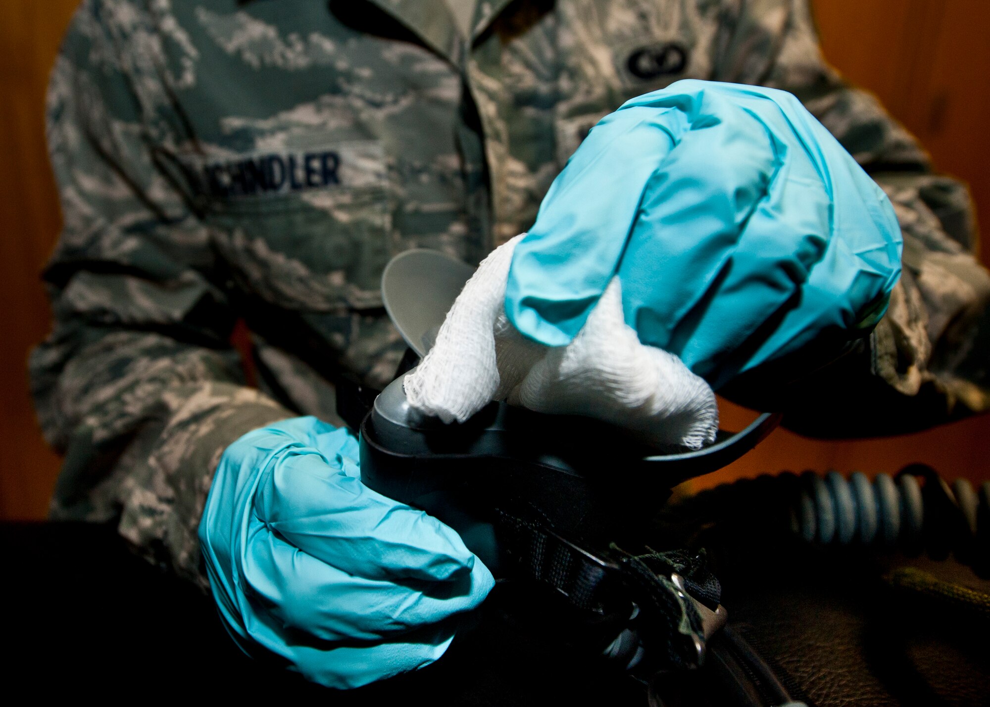 Senior Airman Brett Schindler, U.S. Air Force Weapons School aircrew flight equipment journeyman, sanitizes an oxygen mask April 12, 2013, at Nellis Air Force Base, Nev. Life support maintains various flight equipment such as flight helmets, oxygen masks and survival kits. (U.S. Air Force photo/Senior Airman Brett Clashman)