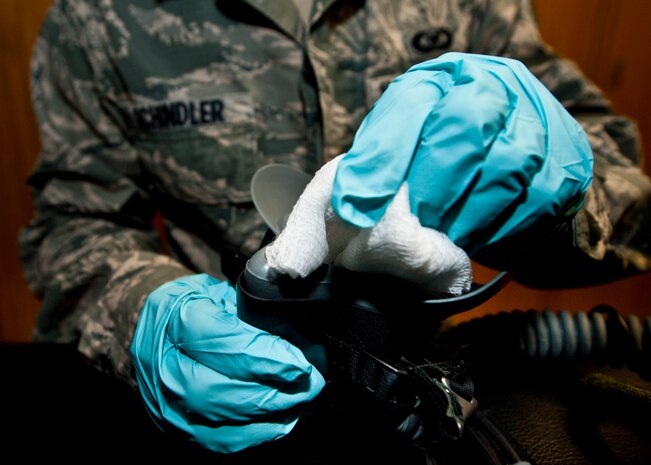 Senior Airman Brett Schindler, U.S. Air Force Weapons School aircrew flight equipment journeyman, sanitizes an oxygen mask April 12, 2013, at Nellis Air Force Base, Nev. Life support maintains various flight equipment such as flight helmets, oxygen masks and survival kits. (U.S. Air Force photo/Senior Airman Brett Clashman)