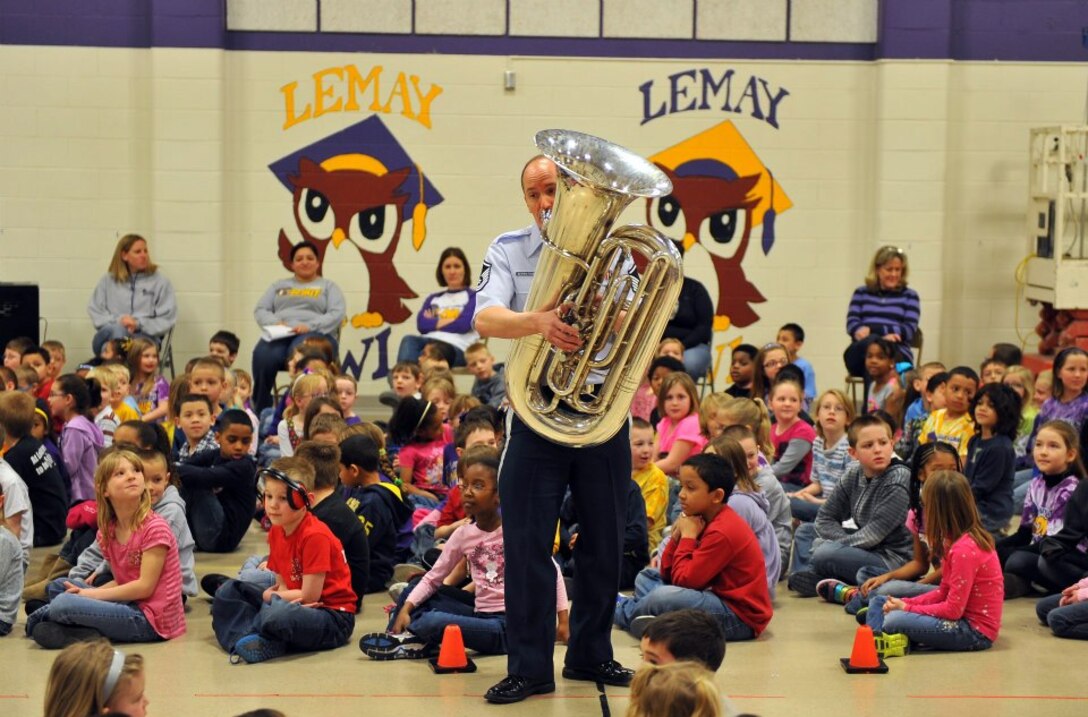 Master Sergeant Alex Serwatowski performs on the tuba with Offutt Brass for local elementary school students