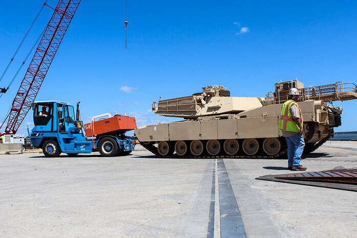 A contractor tows an Abrams tank from Honor of Arc, an American roll-on and roll-off vessel April 10, 2013, at the TC Dock at Joint Base Charleston – Weapons Station, S.C. The 841st Transportation Battalion received and offloaded the final shipment of Abrams battle tanks to be moved to the West Coast.  It ended the 69-year history of the United States Army having their main battle tanks on German soil. (U.S. Army photo/SGT Marcellus Beavers)