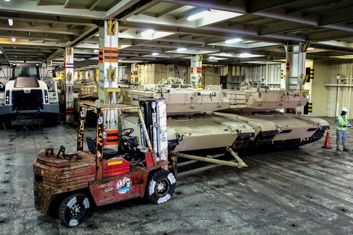 Army SGT.1st Class Timothy Major, 841st Transportation Battalion operations officer, stands ready to oversee contractors off load 22 Abrams tanks to pull from the Honor of Arc, an American roll-on and roll-off vessel April 10, 2013, at the TC Dock at Joint Base Charleston – Weapons Station, S.C. The 841st Transportation Battalion received and offloaded the final shipment of Abrams battle tanks to be moved to the West Coast.  It ended the 69-year history of the United States Army having their main battle tanks on German soil. (U.S. Army photo/SGT Marcellus Beavers)