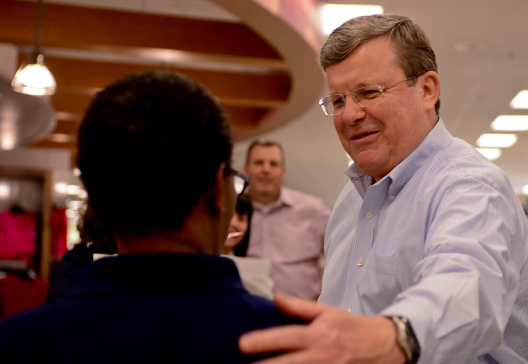 Thomas Shull, Army and Air Force Exchange Service CEO, talks with an employee while touring the Exchange at Fort Eustis, Va., April 10, 2013. The tour helped Shull better understand Joint Base Langley-Eustis’ unique challenges, ensuring AAFES is providing a great environment for JBLE Service members to shop, live and work. (U.S. Air Force photo by Airman 1st Class R. Alex Durbin/Released)