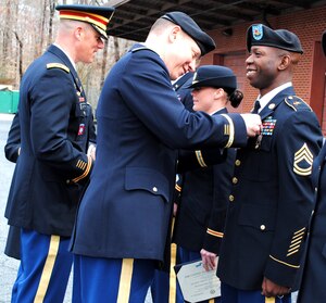 U.S. Army Sgt. 1st Class Onsbey Presley, 53rd Movement Control Battalion soldier, receives a Joint Service Achievement Medal from Col. Burton Shields, U.S. Army Military District of Washington operations officer, for his support during the 57th Presidential Inauguration in Washington, D.C. in January at Fort Eustis, Va., April 5, 2013. The battalion was called to the nation's capital to plan and coordinate the inaugural parade in support of the Presidential Inauguration Committee. 53rd MCB Soldiers were recognized with Certificates of Achievements for their participation, while some were awarded the Joint Service Commendation medal. (U.S. Army photo by Sgt. Marisol Solis/Released)