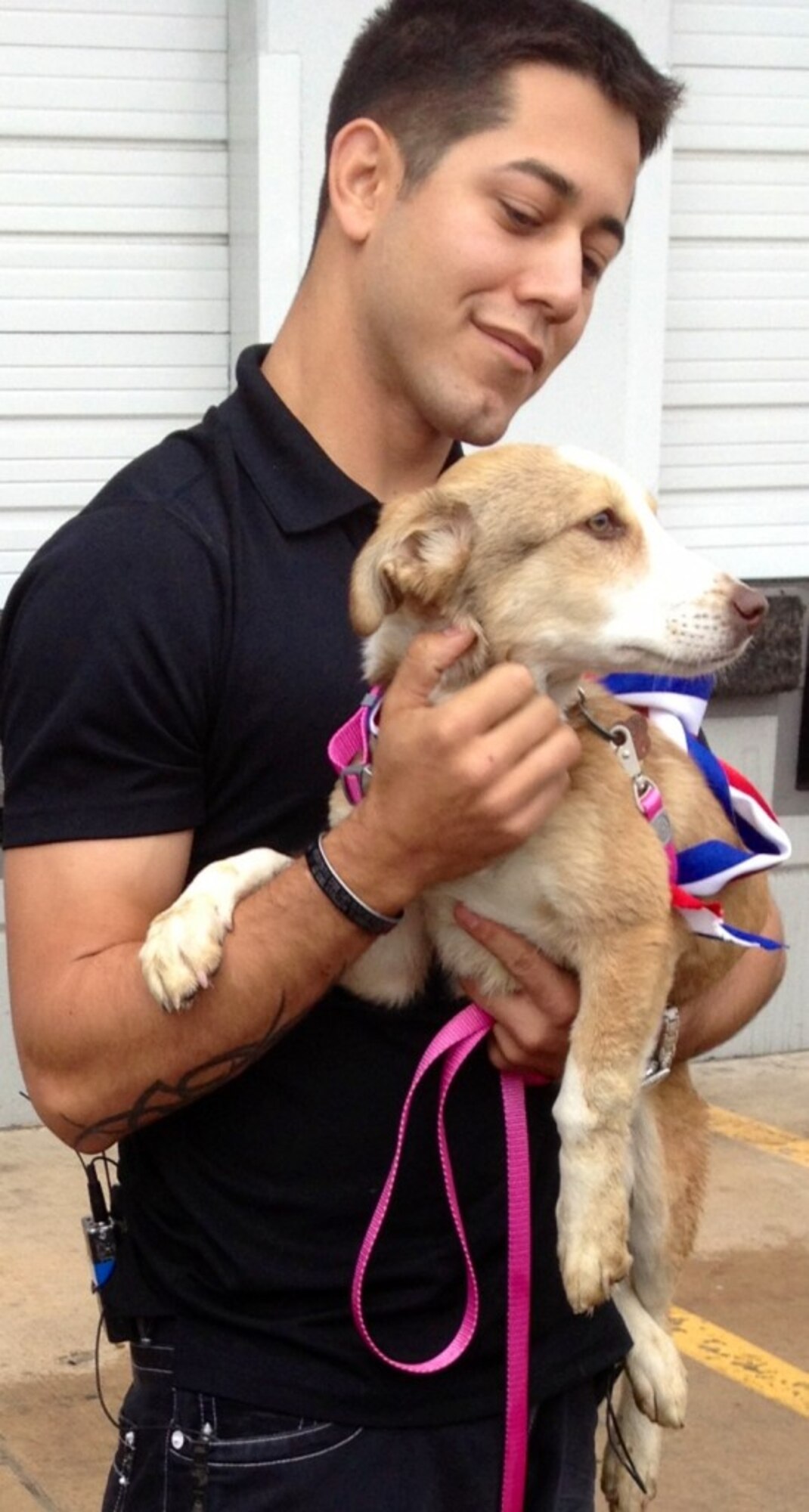 Staff Sgt. Thomas Burright, 7th Logistics Readiness Squadron, is reunited with his dog Lyla April 10, 2013, at Dallas Fort Worth Airport, in Dallas. Lyla, an Afghan Kuchi, was found by Burright while on a patrol near his outpost during a recent deployment to Afghanistan. (Courtesy photo)