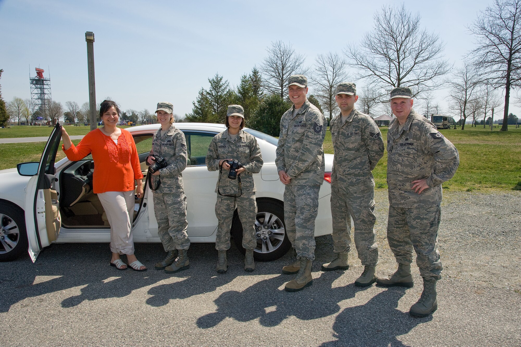 Members of the 436th and 512th Airlift Wing's Public Affairs sections pose for a group photo near Dover's FamCamp during specialized training that prepared them to respond to alert and investigative response photography needs at Dover Air Force Base, Del. recently. After completing classroom portions of the training, each person was sent to respond to a staged accident/crime scene and tasked with fully documenting the details. (U.S. Air Force photo/Greg L. Davis)