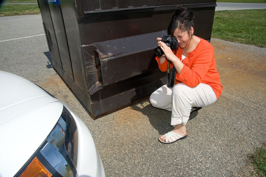Veronica Aceveda, 512th Airlift Wing Public Affairs, Air Force Reserve Command, documents a staged accident scene as part of hands-on training, Dover Air Force Base, Del., April 11, 2013. Military members of the 436th and 512th Airlift Wing's Public Affairs sections undertook specialized training to prepare them to respond to alert and investigative response photography needs at Dover Air Force Base, Del. recently. After completing classroom portions of the training, each person was sent to respond to a staged accident/crime scene and tasked with fully documenting the details. (U.S. Air Force photo/Greg L. Davis)