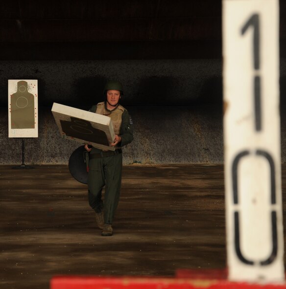 An Airman from the 11th Bomb Squadron moves his target during an M-9 Air Force Qualification Course on Barksdale Air Force Base, La., April 16, 2013. Airmen are taught various shooting positions and stances they must demonstrate in order to receive completion on the course. (U.S. Air Force photo/Senior Airman Sean Martin)