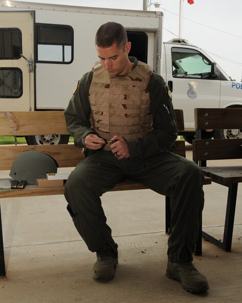 Maj. Adam Newell, 2nd Aerospace Medical Squadron flight surgeon, loads rounds into a magazine during an M-9 Air Force Qualification Course on Barksdale Air Force Base, La., April 16, 2013. Airmen are given 90 rounds to shoot. Half the rounds are used for practice and the other half are used for qualification. (U.S. Air Force photo/Senior Airman Sean Martin) (RELEASED)