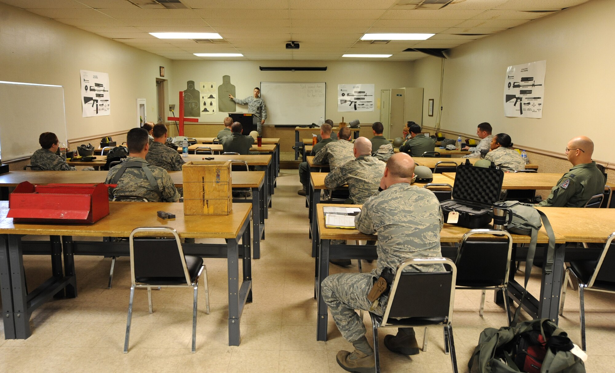 Senior Airman Avery Ward, 2nd Security Forces Squadron Combat Arms instructor, gives shooting instructions to Airmen during an M-9 qualification class on Barksdale Air Force Base, La., April 16, 2013. Airmen are taught various shooting positions and stances they must demonstrate in order to receive completion on the course. (U.S. Air Force photo/Senior Airman Sean Martin)