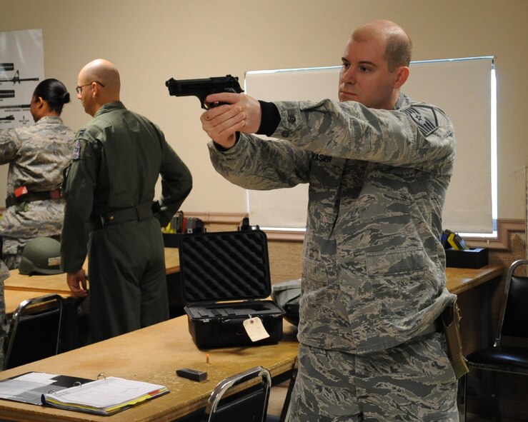 Master Sgt. Sean Brasier, 2nd Maintenance Group Quality Assurance chief inspector, practices a firing stance during an M-9 qualification class on Barksdale Air Force Base, La., April 16, 2013. The class consists of two parts, a classroom and a hands-on session. (U.S. Air Force photo/Senior Airman Sean Martin)