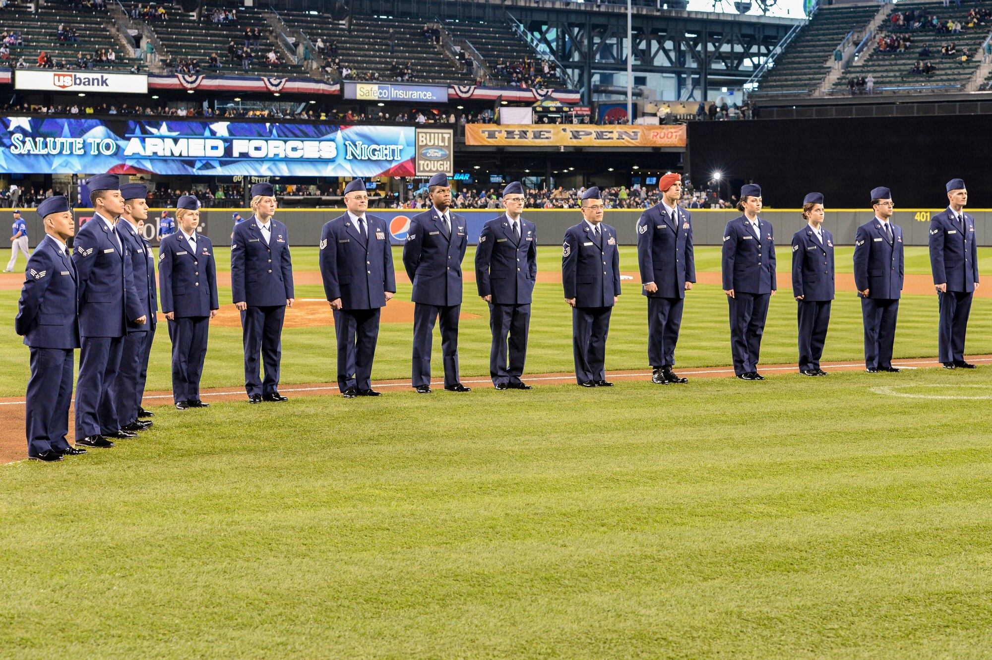 Airmen from the 62nd and 446th Airlift Wings, along with members of the Washington Air National Guard, stand on the baselines during the opening ceremonies of the Seattle Mariners Salute to Armed Forces Night, April 13, 2013, at Safeco Field in Seattle, Wash. The event is held each year by the Mariners in order for the team to show their appreciation to servicemembers serving throughout the Puget Sound area. (U.S. photo/Tech. Sgt. Sean Tobin)