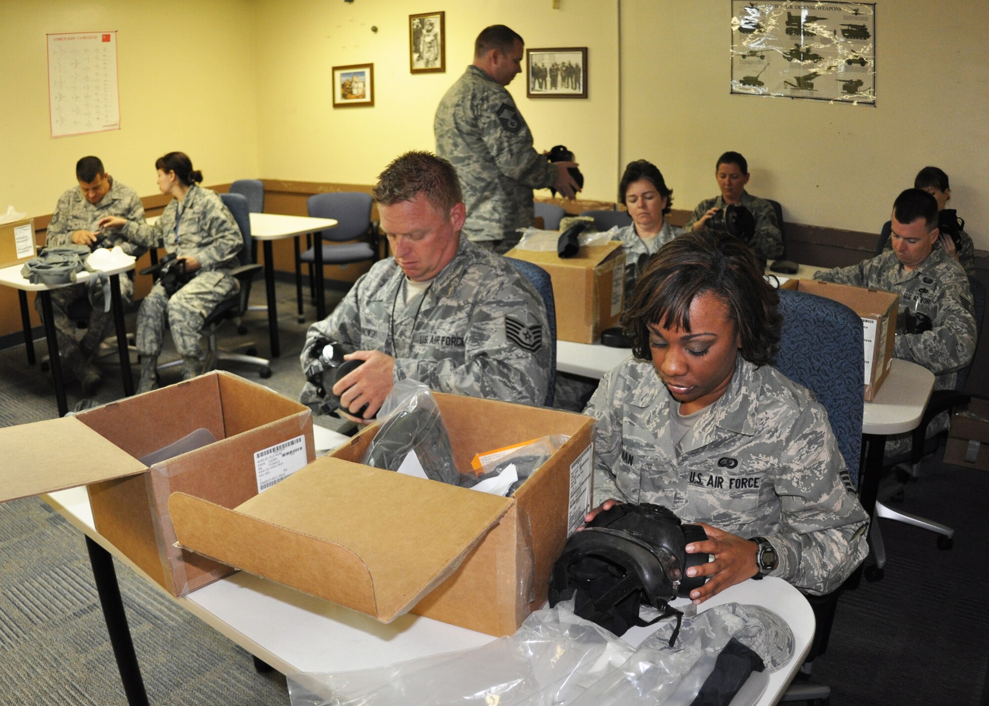 Tech. Sgt. Donald Malinowski and Staff Sgt. Chanel Coleman of the 919th Force Support Squadron inspect their M-50 gas masks in a chemical warfare defense training class April 5, 2013 at Duke Field, Fla.   The class was one of many mass training events held during the annual four-day Super Unit Training Assembly.  The SUTA gives traditional reservists more time and opportunities to complete their mandatory ancillary and unit training requirements. (U.S. Air Force photo/Dan Neely) 