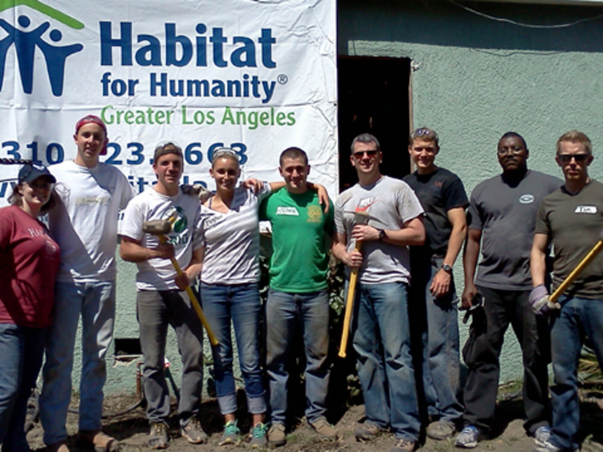 SMC’s Development Planning Directorate team volunteers pause for a break during a Habitat for Humanity house rebuild in Los Angeles, April 13.  (Courtesy photo)