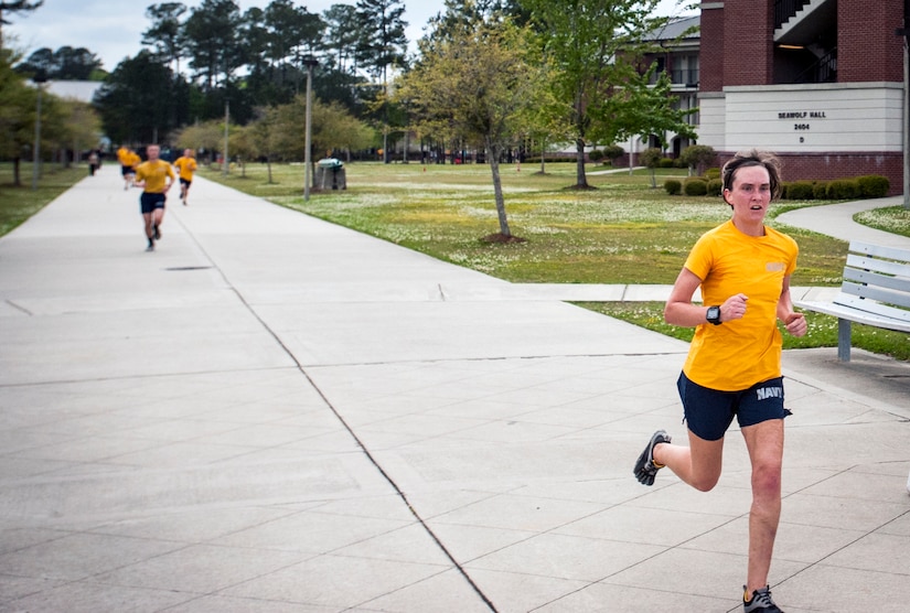 Ensign Jennifer Oblinger, Naval Nuclear Power Training Command instructor, crosses the finish line during the Sexual Assault Awareness 5k Run April 11, 2013, at Joint Base Charleston – Weapons Station, S.C. It is estimated that more than 2,400 Sailors are victims of sexual assault every year. The run was held to bring awareness to sexual assault. Oblinger finished as the top female participant with a time of 21:23. (U.S. Air Force photo / Airman 1st Class Tom Brading)