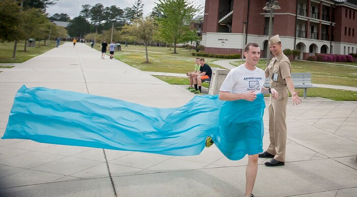 Navy Lt. j.g. Michael Johnson, Naval Nuclear Power Training Command instructor, crosses the finish line during the Sexual Assault Awareness 5k Run April 11, 2013, at Joint Base Charleston – Weapons Station, S.C. It is estimated that more than 2,400 Sailors are victims of sexual assault every year. The run was held to bring awareness to sexual assault. Johnson finished as the top male participant with a time of 18:54. (U.S. Air Force photo / Airman 1st Class Tom Brading)