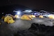 The tents of the U.S. Air Force Seven Summit team are illumated at night at a base camp near Mount Everest. A team of six active-duty Airmen is currently on their way to climb Mount Everest, the highest mountain on Earth, to suppoort resilience, raise money for charity and commemorate their fallen. (Courtesy photo/USAF Seven Summit Challenge) 