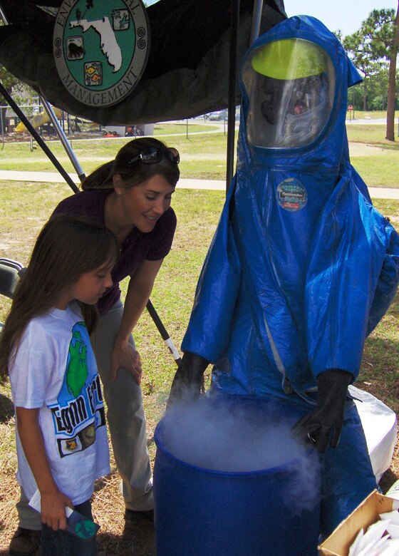 Beth Behr, from the 96th Environmental Management, looks at a mock hazardous material display with an Eglin Elementary School student during Eglin's 2012 Earth Week celebration. Eglin's 2013 Earth Week activities include kayak ecotours of Eglin's streams and habitats, a nature hike, a cleanup on the reservation, the annual 5K Fun Run and an eco-mountain bike tour. For more information, or to sign up for one of the events, e-mail Erica Laine at erica.laine.ctr@eglin.af.mil.  (Courtesy photo)
