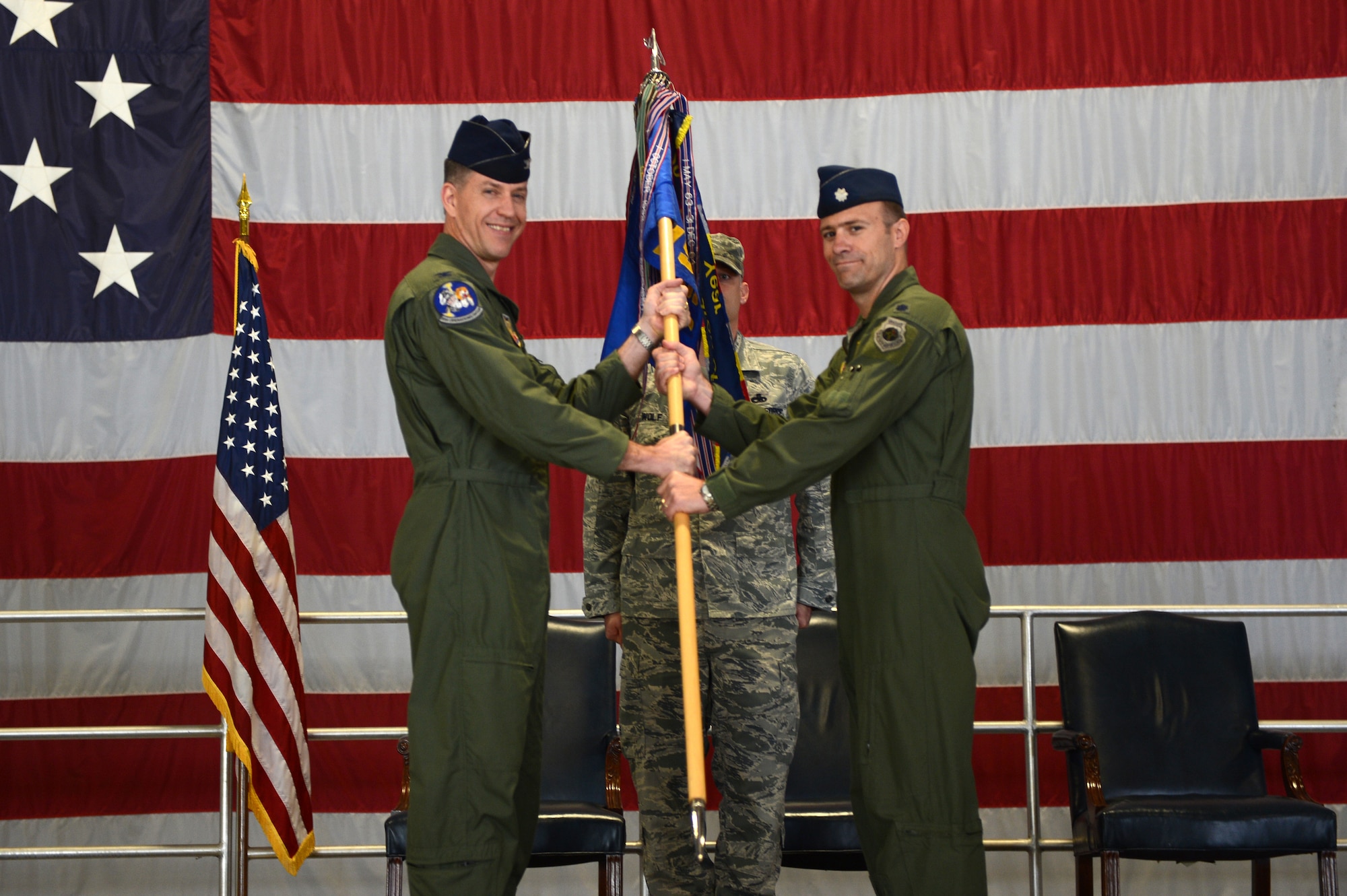 Col. Shaun McGrath (left), 20th Operations Group commander, passes the ceremonial guidon to Lt. Col. Raymond Millero, 79th Fighter Squadron (acting) commander during a change of command ceremony at Shaw Air Force Base, S.C., April 12, 2013. A Change of command is a military tradition that represents the transfer of responsibilities from the presiding official to a qualified selected official. (U.S. Air Force photo by Airman 1st Class Daniel Blackwell/released)