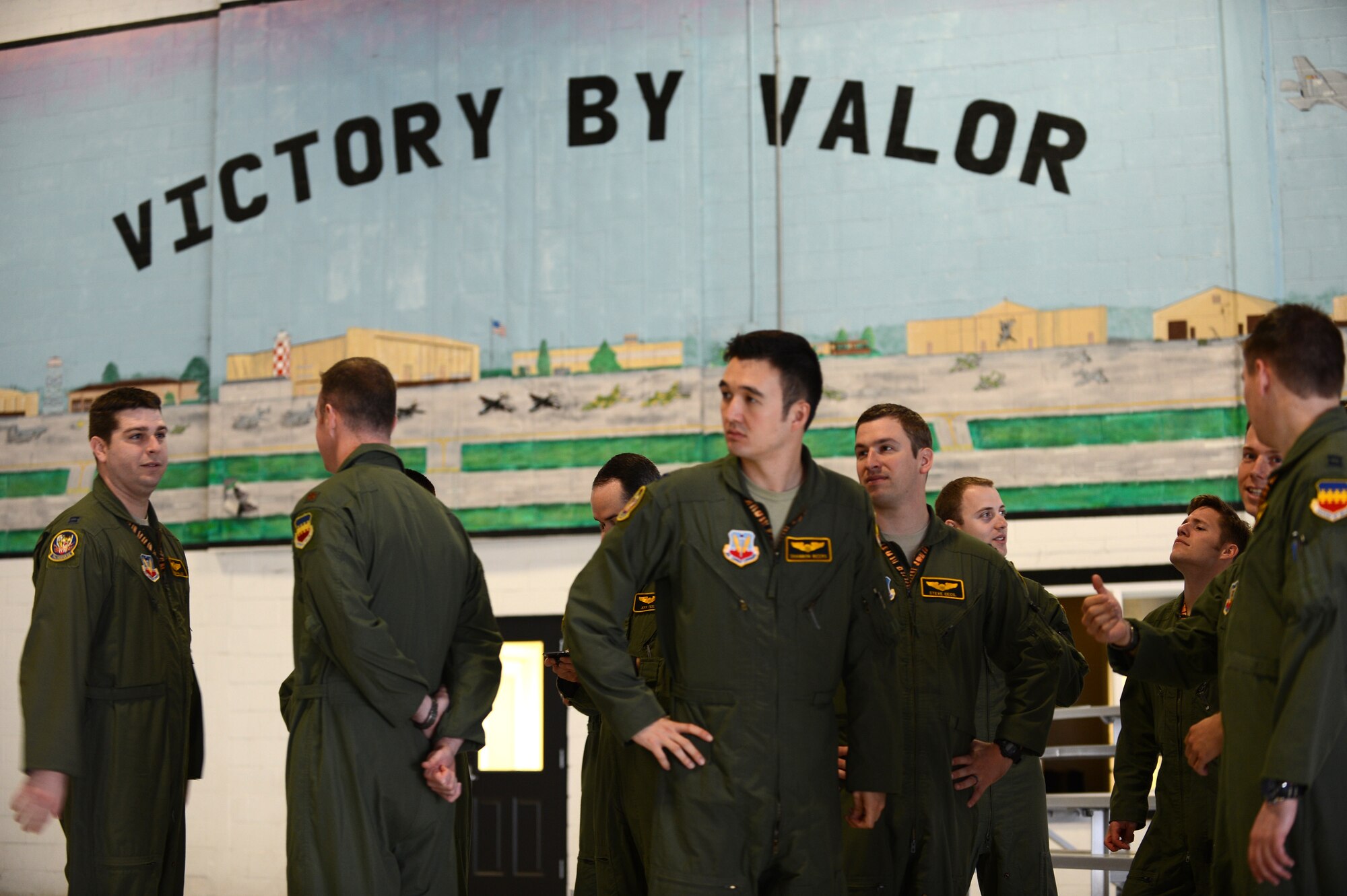 Pilots of the 79th Fighter Squadron gather in hanger 1200 as they prepare to render military courtesies during the change of command, at Shaw Air Force Base, S.C., April 12, 2013. A Change of command is a military tradition that represents the transfer of responsibilities from the presiding official to a qualified selected official. (U.S. Air Force photo by Airman 1st Class Daniel Blackwell/released)