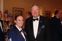 WASHINGTON, D.C. -- Staff Sgt. Arrin Tune, 91st Operations Support Squadron, takes a picture with the Secretary of the Air Force Michael B. Donley at the Air Force Charity Ball in Washington D.C. Staff Sgt. Tune recently spoke at the event, specifically requested by the Air Force Aid Society, to talk about her experiences of the Minot flood of 2011 and its aftermath. (Courtesy photo)