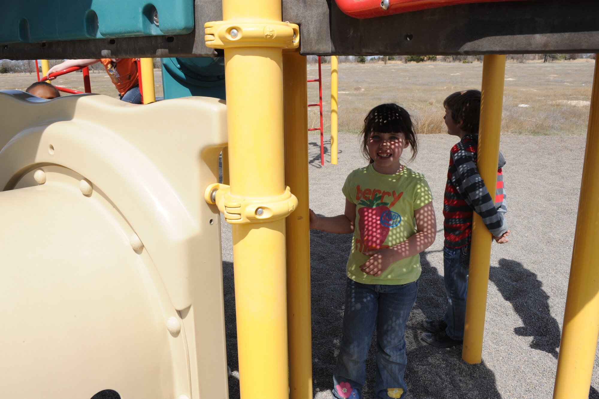 A child plays underneath the jungle gym April 3, 2013, at Mountain Home Air Force Base, Idaho. April is Month of the Military Child and the base is celebrating by holding multiple events. (U.S. Air Force photo by Airman 1st Class Malissa Lott/Released)