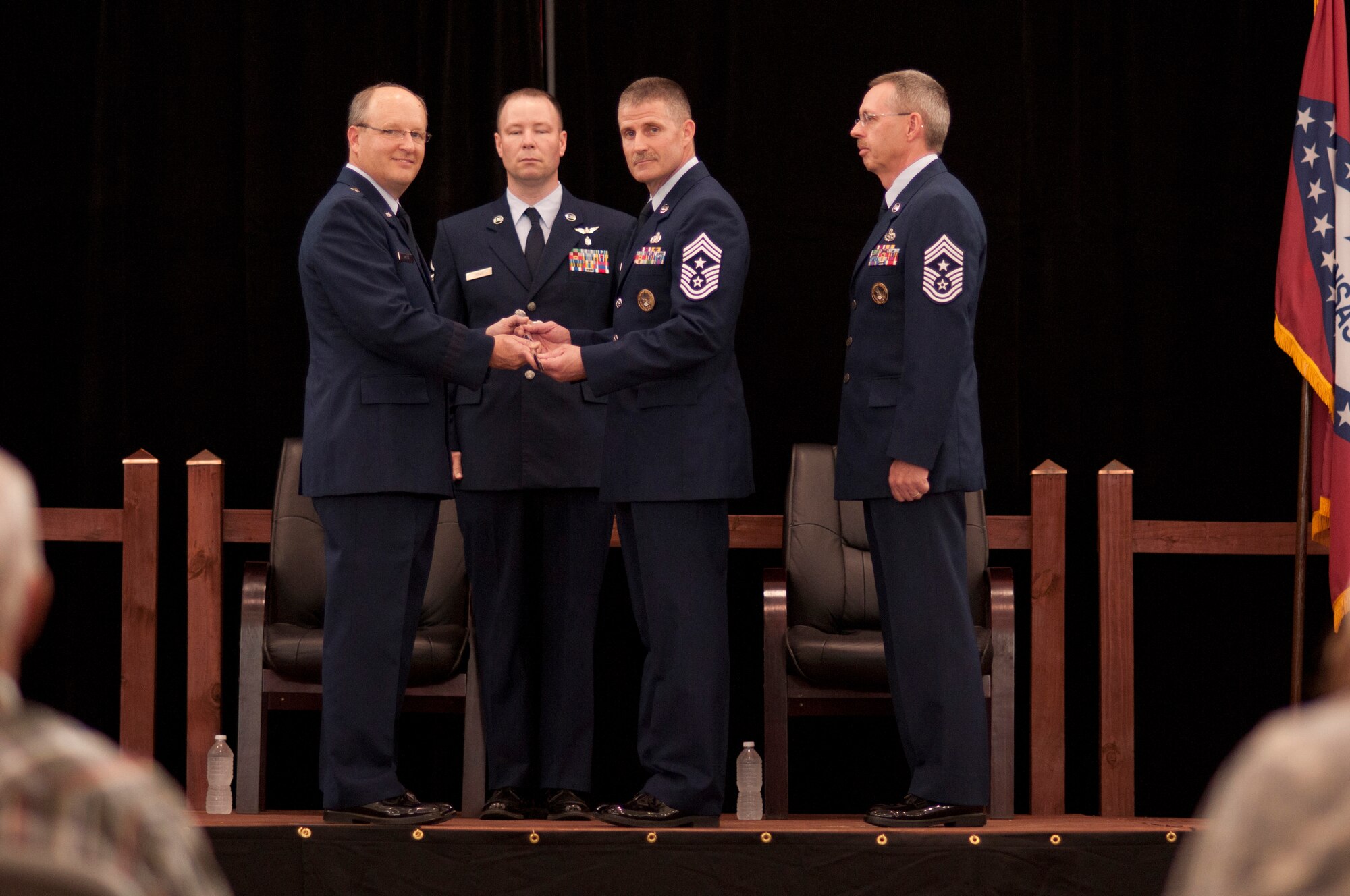 Command Chief Master Sgt. Asa Carter assumes the position of the Arkansas Air National Guard state command chief from Brig. Gen. Dwight Balch, Arkansas Air National Guard commander, April 7, 2013, at Little Rock Air Force Base, Ark., as First Sgt. Jassen Travis and Command Chief Master Sgt. Stephen W. Arnold look on. Arnold relinquished his authority as state command chief during the ceremony. Carter served as the 188th Fighter Wing’s command chief for six years. (National Guard photo by Senior Airman Ian Caple)
