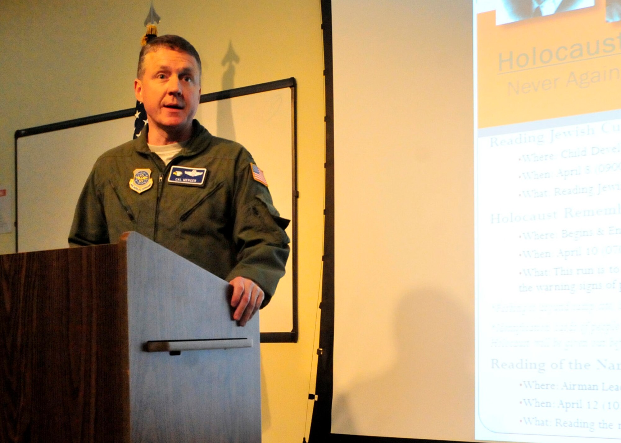 Col. Cal Mercer, 436th Airlift Wing deputy commander, addresses the audience during the Holocaust Remembrance Ceremony April 12, 2013, at Dover Air Force Base, Del. Mercer spoke of remembering how entire countries saw their Jewish populations decrease significantly as a result of the Holocaust. (U.S. Air Force photo/Tech. Sgt. Chuck Walker)