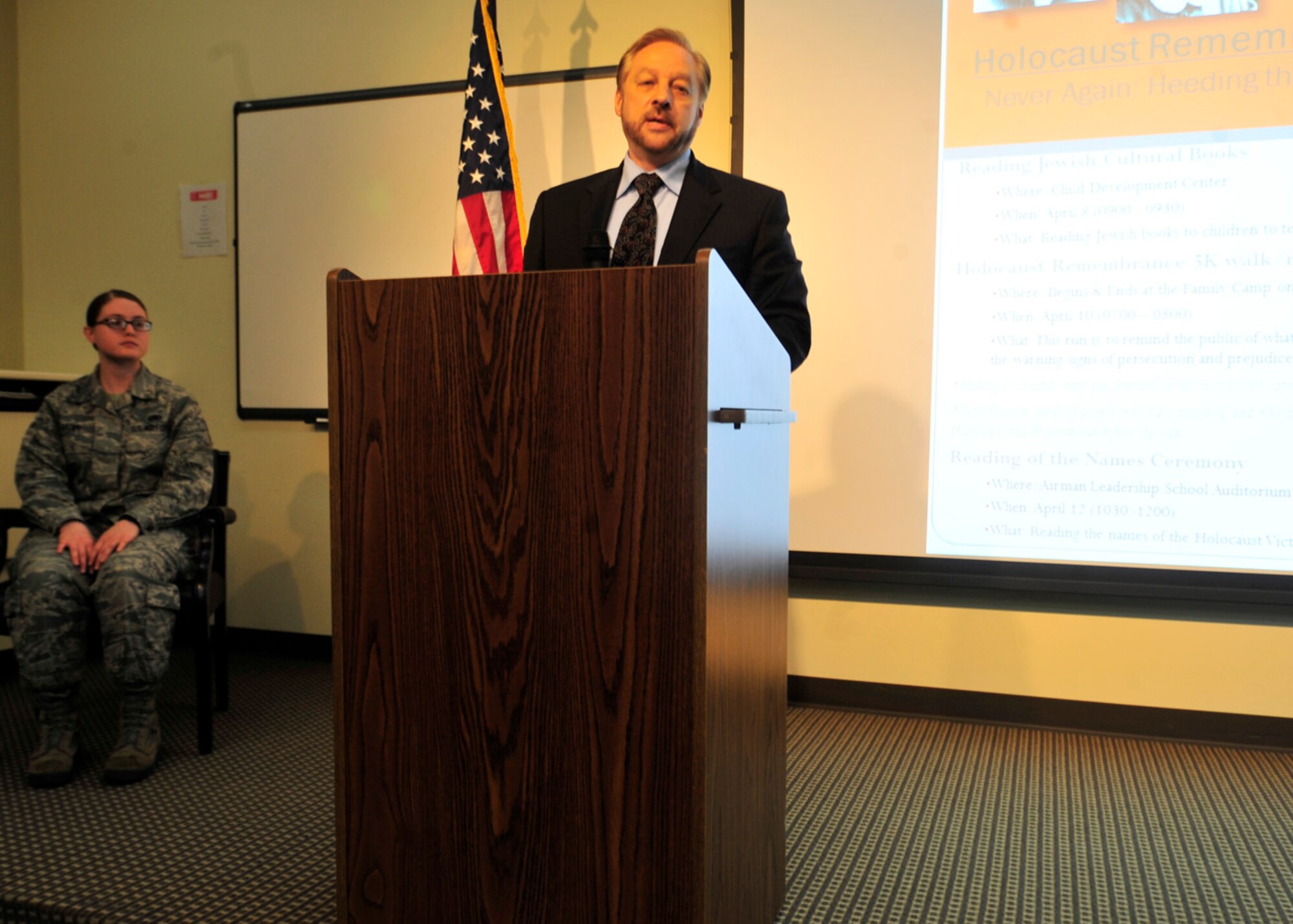 Steve Gonzer, documentary filmmaker and member of the Halina Wind Preston Holocaust Education committee, speaks during the Holocaust Remembrance Ceremony April 12, 2013, at Dover Air Force Base, Del. Gonzer encouraged those present to remember and never forget the victims of the Holocaust. (U.S. Air Force photo/Tech. Sgt. Chuck Walker)