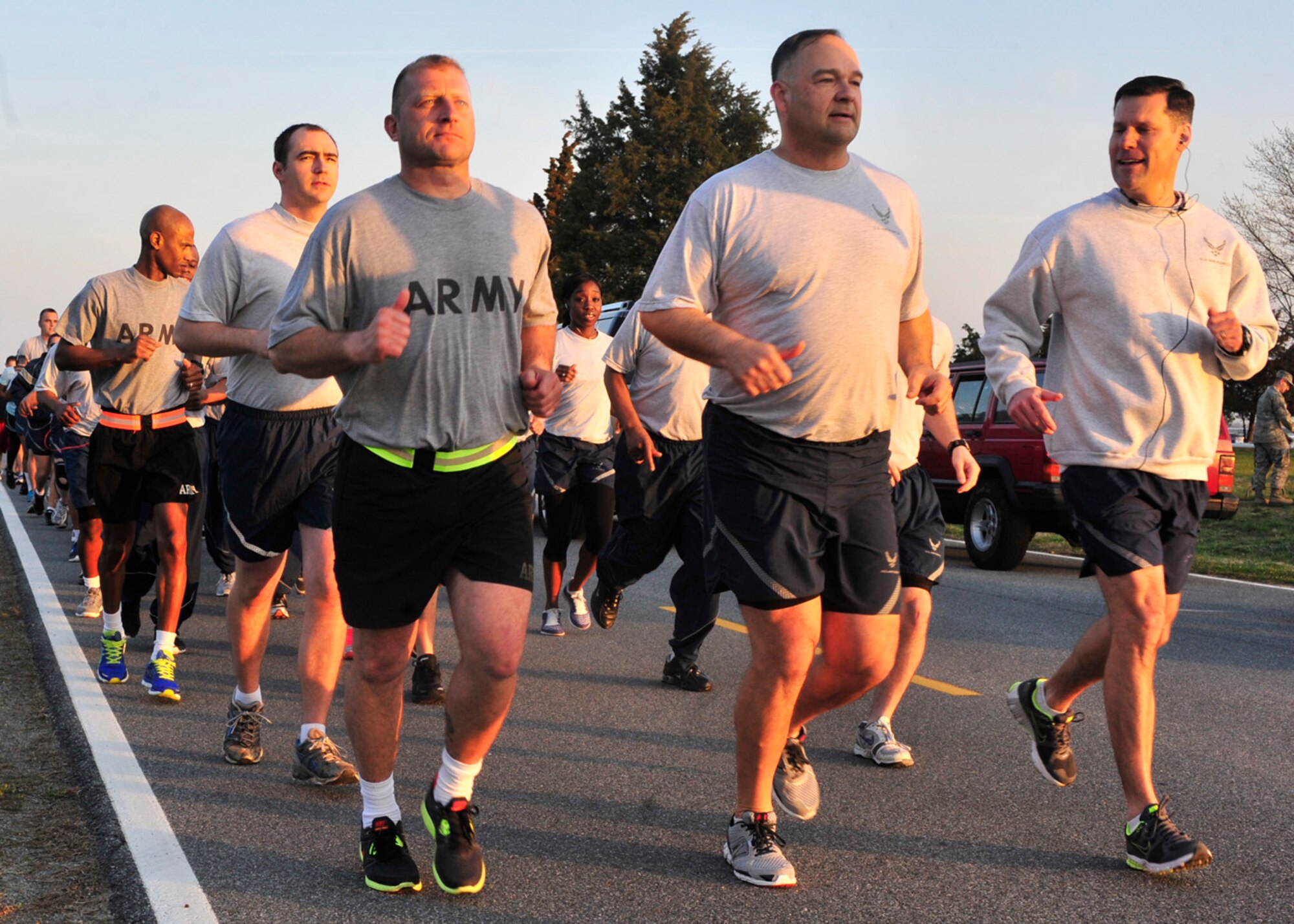 (Left to Right) U.S. Army Sgt. 1st Class Christopher Chesonis, of the Army Liaison Team, Lt. Col. David Kretz, Air Force Mortuary Affairs Operations deputy commander, and Col. John Devillier, AFMAO commander, lead a group of runners from AFMAO at the Holocaust Remembrance Run April 10, 2013, at Dover Air Force Base, Del. Each participant in the event ran with the identification of a victim of the Holocaust to remember the victims. (U.S. Air Force photo/Tech. Sgt. Chuck Walker)