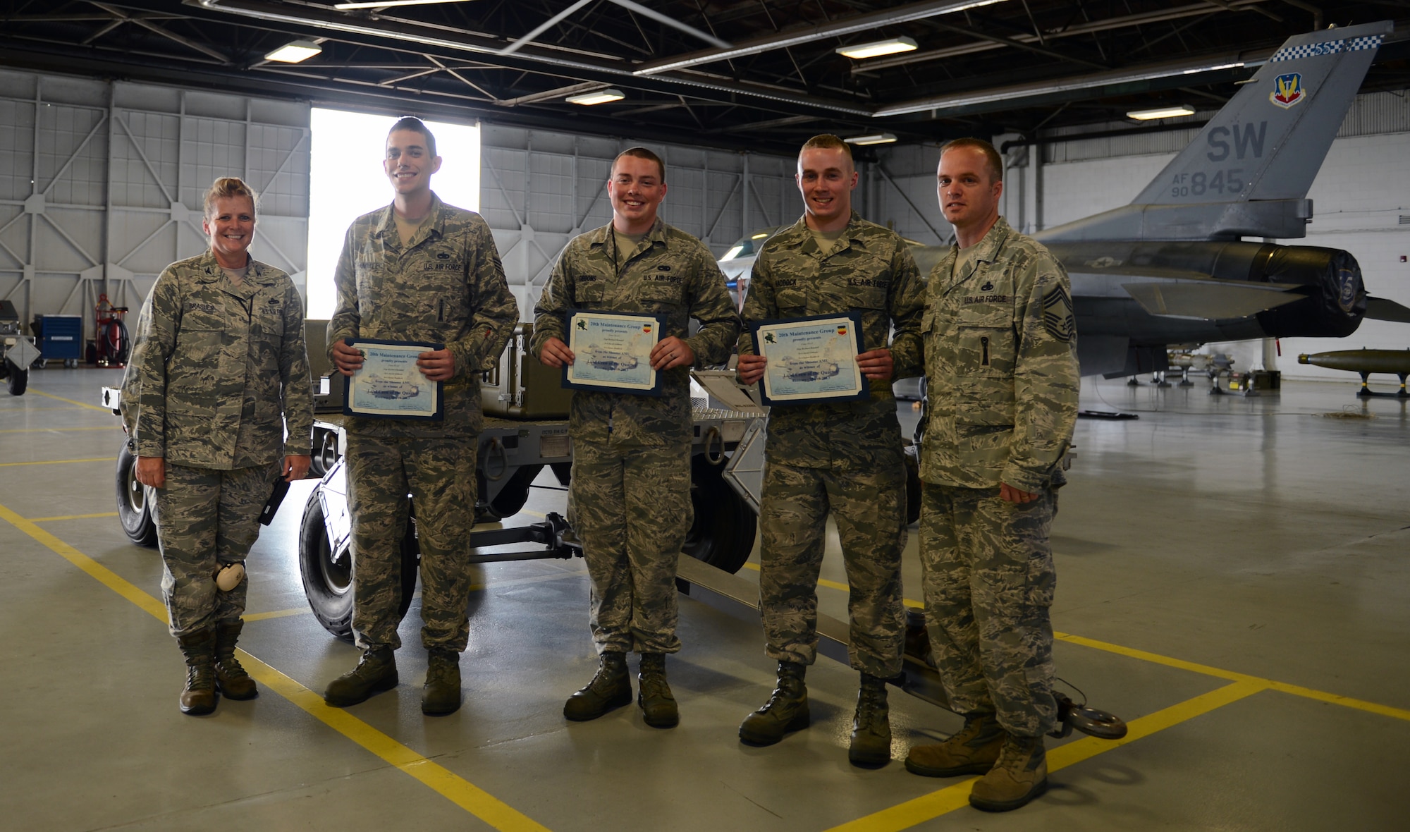 U.S. Air Force Col. Helen Brasher, 20th Maintenance Group commander, and Chief Master Sgt. Anthony Bomar, 20th MXG wing weapons manager, present
Staff Sgt. Richard Randall, 55th Aircraft Maintenance Unit ?Shooters,? weapons load crew chief, Senior Airman Jacob Gibbons, 55th AMU ?Shooters,? weapons load crew member, and Senior Airman Dylan Haddock, 55th AMU ?Shooters,? weapons load crew member, winners of the Weapons Load Competition of the Quarter certificates at Shaw Air Force Base, S.C., April 12, 2013. The 55th AMU ?Shooters? and 79th AMU ?Tigers? competed against one another during the Weapons Load Crew of the Quarter. (U.S. Air Force photo by Senior Airman Tabatha Zarrella/Released)
