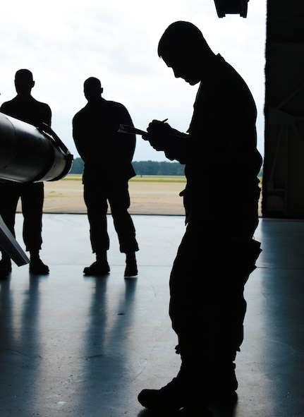 U.S. Air Force Staff Sgt. Matthew Delpit, 79th Aircraft Maintenance Unit ?Tigers,? weapons load crew chief, completes his checklist for his load team at Shaw Air Force Base, S.C., April 12, 2013. The 55th AMU ?Shooters? and 79th AMU ?Tigers? competed against one another during the Weapons Load Crew of the Quarter. (U.S. Air Force photo by Senior Airman Tabatha Zarrella/Released)