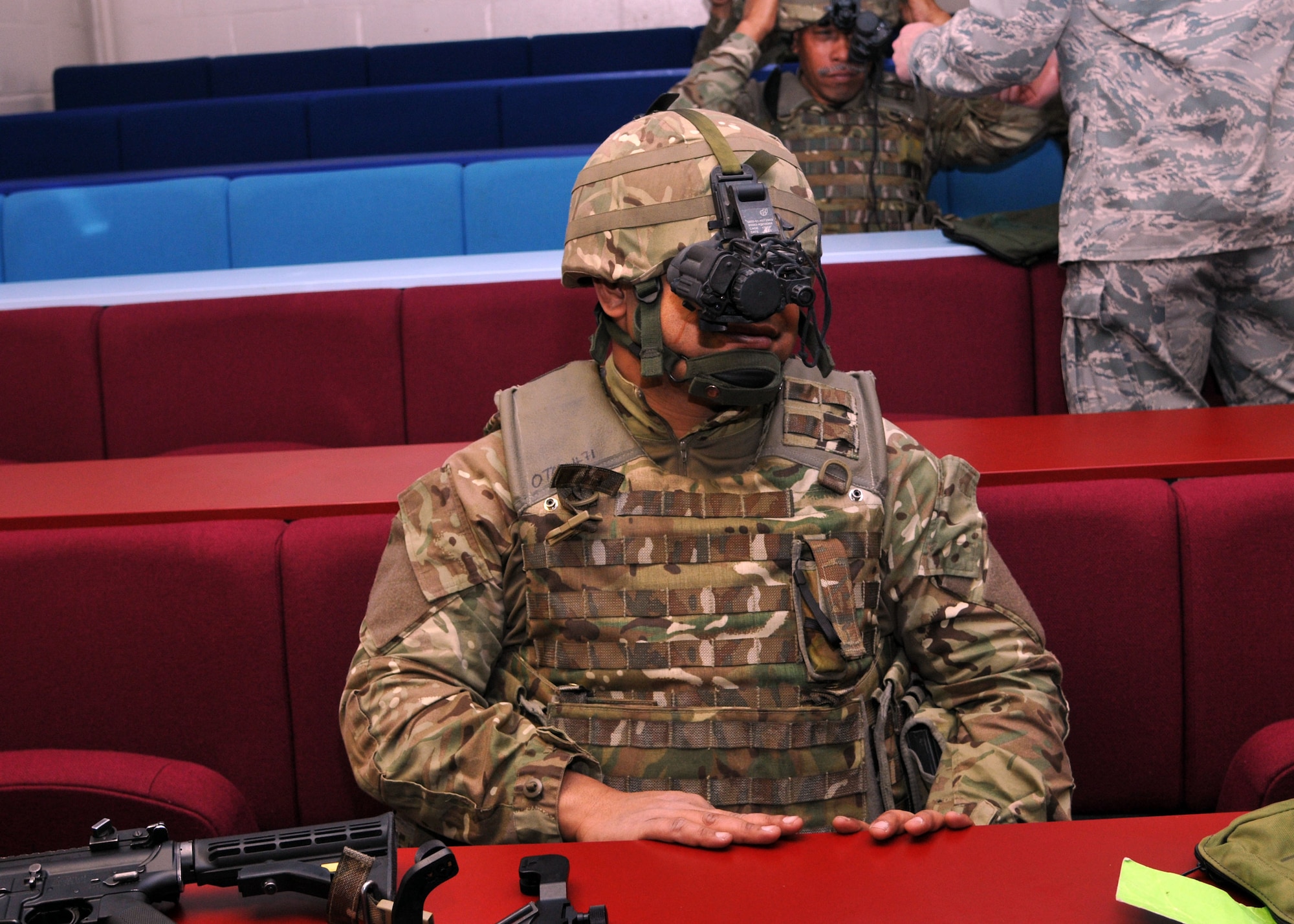 Tongan Defence Force Pvt. Alo Taneli, Contingent 6, tries on a monocular night vision goggle during training with the 100th Security Forces Squadron April 15, 2013, at RAF Honington, England. The TDF learned how to mount NVGs to their helmets, as well as their weapons, and how to operate them. (U.S. Air Force photo by Airman 1st Class Kelsey Waters/Released)