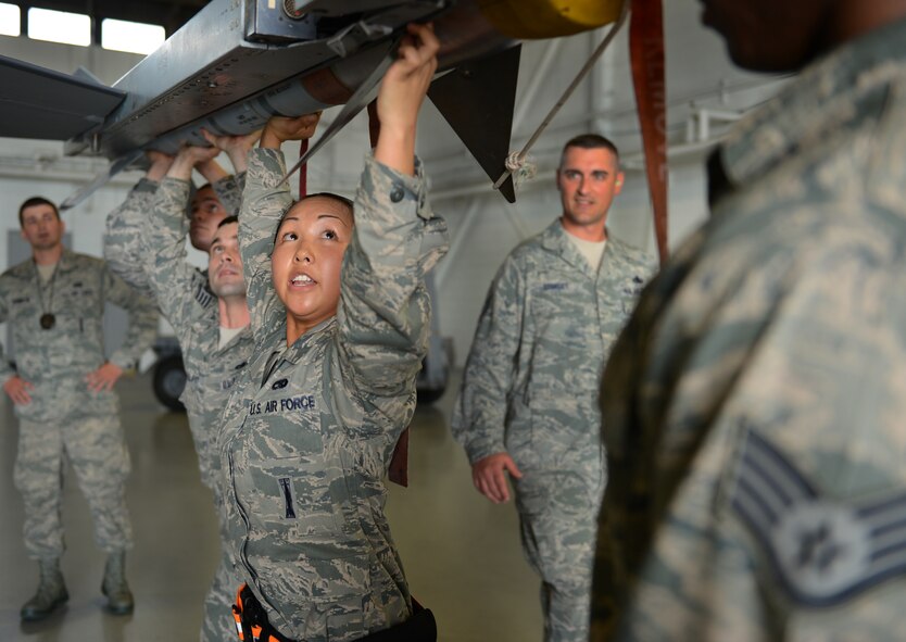 U.S. Air Force Senior Airman Yen Do, 79th Aircraft Maintenance Unit ?Tigers,? weapons load crew member, ensures that an Air Intercept Missile-9LM is properly attached to an F-16 Fighting Falcon at Shaw Air Force Base, S.C., April 12, 2013. The 55th AMU ?Shooters? and 79th AMU ?Tigers? competed against one another during the Weapons Load Crew of the Quarter. (U.S. Air Force photo by Senior Airman Tabatha Zarrella/Released)