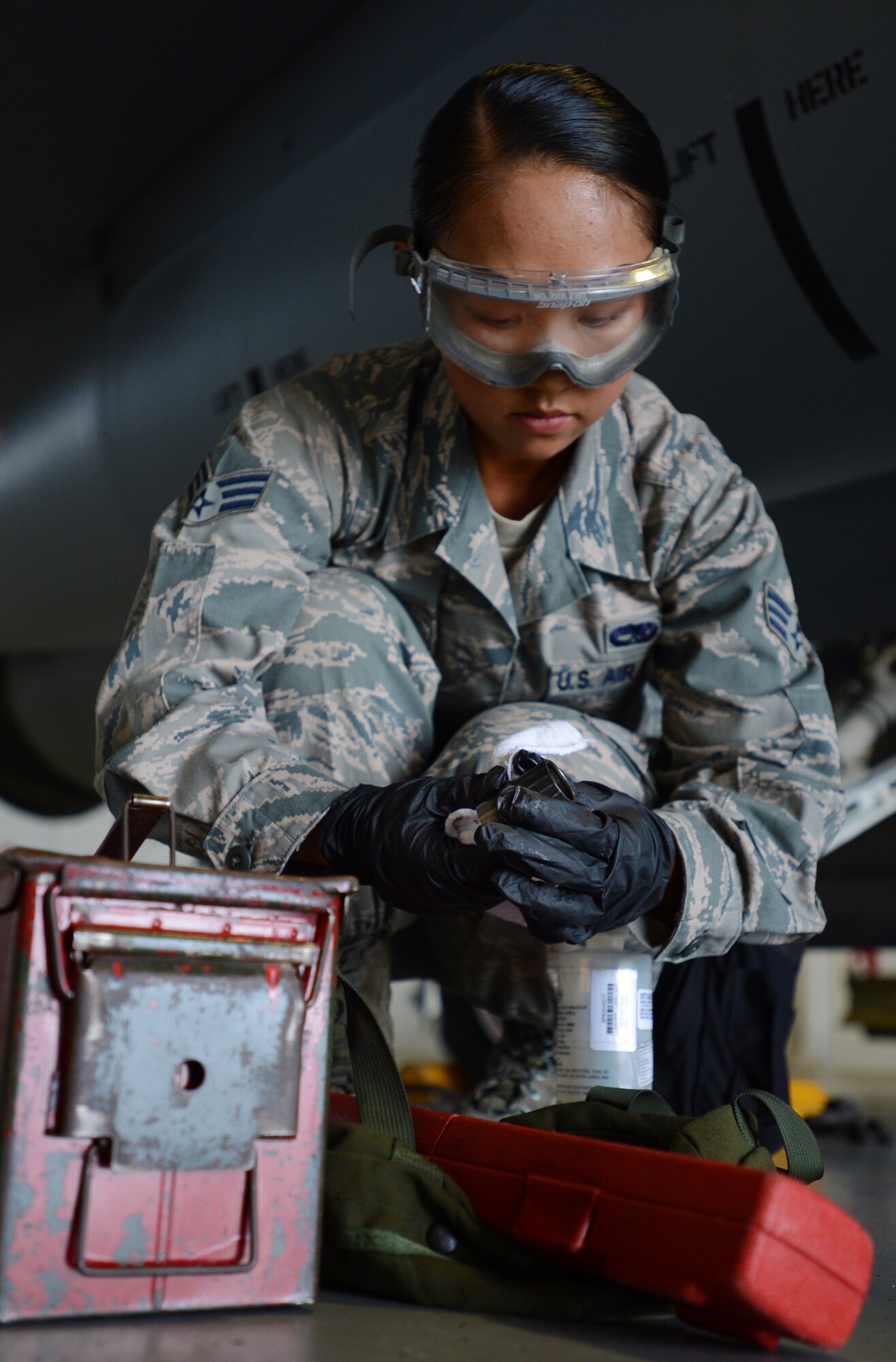 U.S. Air Force Senior Airman Yen Do, 79th Aircraft Maintenance Unit ?Tigers,? weapons load crew member, applies break-free lubricant to the impulse cartridges retainers at Shaw Air Force Base, S.C., April 12, 2013. The 55th AMU ?Shooters? and 79th AMU ?Tigers? competed against one another during the Weapons Load Crew of the Quarter competition. (U.S. Air Force photo by Senior Airman Tabatha Zarrella/Released)
